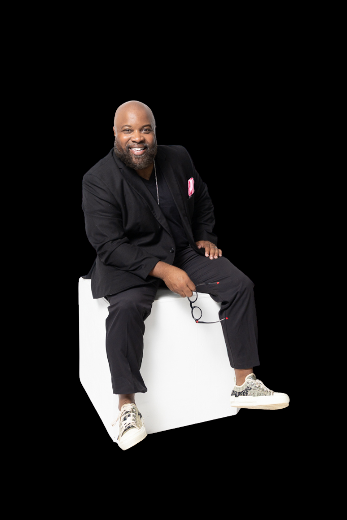 Phillip Edge seated in a black suit